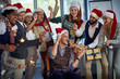 © luckybusiness - People celebrating Christmas together at work.