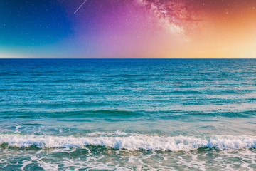 Wall Mural - night sky, milky way galaxy stars and space with sea or ocean and waves at the beach.