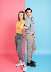 Wall Mural - Portrait Of Happy Young  Couple with showing  gesture