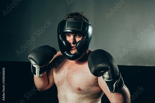 Принти на полотні Portrait of male boxer wearing gloves and helmet at gym