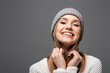 © LIGHTFIELD STUDIOS - attractive smiling girl in knitted hat and sweater, isolated on grey