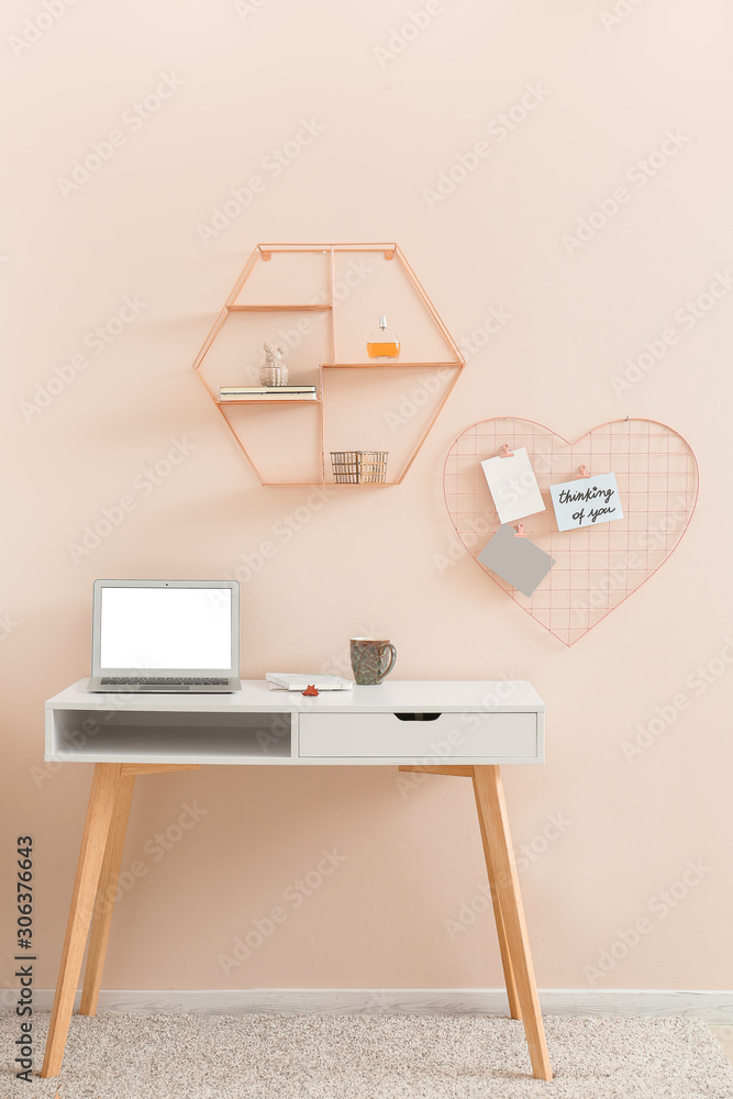 Modern comfortable workplace near color wall
