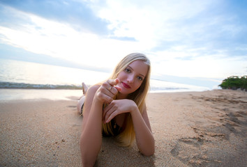 Fashion and Glamour Portrait of pretty beautiful fashion woman in black bikini posing in summer near the sea and sunset sky in evening,tropic island girl on vacation