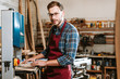 © LIGHTFIELD STUDIOS - handsome woodworker in safety glasses looking at camera