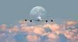 © muratart - White passenger airplane in the clouds with full moon - Travel by air transport 'Elements of this image furnished by NASA'
