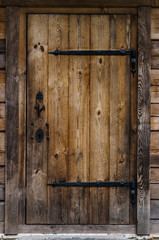 Old door from wooden boards to the bathhouse.