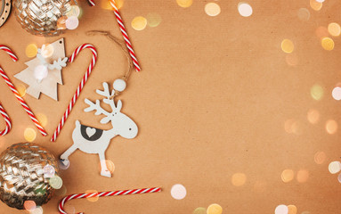  Wooden Christmas toys, balls and candy canes on a brown background copy space.