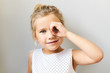 © Anatoliy Karlyuk - Horizontal shot of adorable pretty girl in beautiful dress posing in studio looking through binocular made of her hand, connecting thumb with fore finger. Cute funny female child having fun, spying