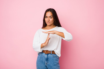 Wall Mural - Young mixed race indian woman showing a timeout gesture.