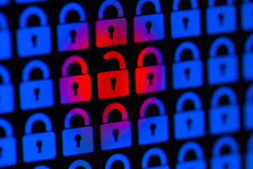 Open padlock as a symbol of the loss of personal information. Hacking or open data. Blue and red pixel locks on a black background, close up