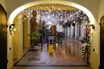 CLOSE UP: Entrance gates to a cafe are illuminated by festive Christmas lights.