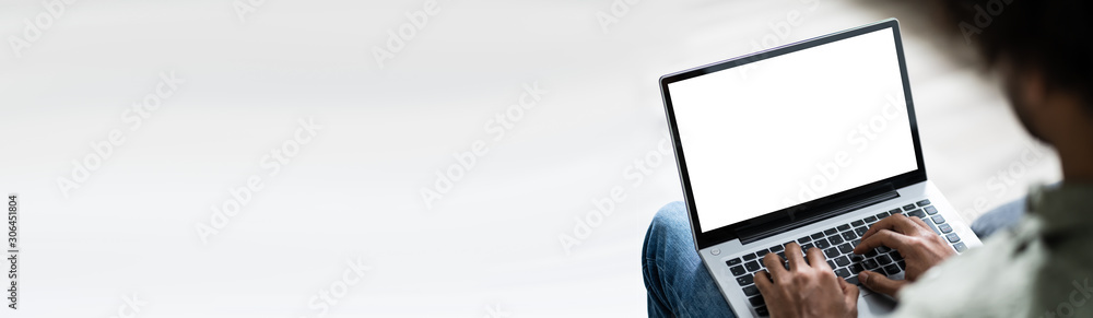 Young Man Using Laptop At Home - obrazy, fototapety, plakaty 