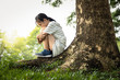 Depressed asian child girl was sitting alone crying and thinking about problems  at park,sad female teenage having psychological trouble with depressive symptoms feel despair suffering from depression