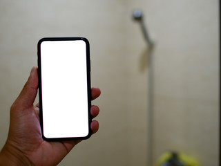 Smart phone with white screen background in bathroom, bath or toiletry. Closeup of hands using mobile phone with blank copy space screen, empty white screen for advertising text in bath room