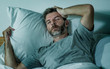 © TheVisualsYouNeed - young sad and depressed man lying thoughtful and pensive on bed looking away feeling lost thinking suffering some problem in sadness emotion and depression concept
