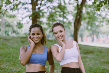 Happy young sporty girl smiling together at public park in the morning,Relaxing time