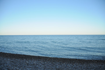  Mediterranean sea stones beach landscape at sunset