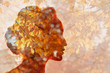 © primipil - Autumn season concept. Head silhouette of a beautiful young woman on a background of autumn leaves.