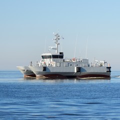 Canvas Print - Grey modern warship sailing in still water