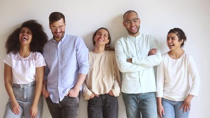 diverse happy people standing in row laughing looking at camera