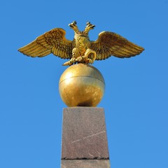 Two-headed Russian eagle. Golden architectural detail against blue sky.