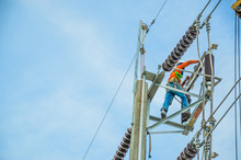 Electricians Are Climbing On Electric Poles To Install And Repair Power Lines.