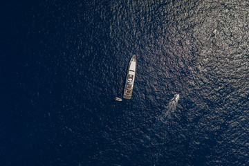 Wall Mural - Aerial overhead drone shot of luxury yacht in Tyrrhenian sea near Capri Island in summer