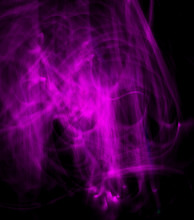 Long Exposure, Light Painting Photography, Purple And Pink Swirl Against A Black Background. Ghost Shape.