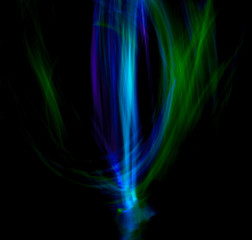 Long exposure blue and green light lines movement. Long blue and green gradient exposure neon lights texture.