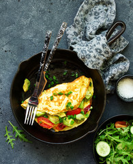 Wall Mural - omelet with avocado, tomatoes and cheese for breakfast.