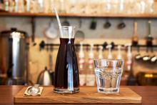 Glass With Cold Brew Coffee And Glass With Water On A Coffee Shop Counter