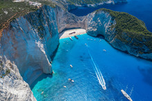 Aerial Drone Shot Of Zakynthos Navagio Beach With Tourists With Cruise Ship In Blue Ionnian Sea