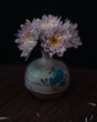 bouquet of flowers in vase on black background