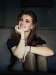 © sergeyzapotylok - Portrait of a cute pretty redhead woman sitting in a cafe enjoying free time coffee break еhoughtfully looking into camera hugging knees