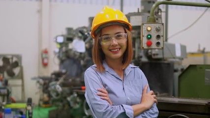 Poster - Asian  engineer wearing a Yellow safety helmet and she smiled .