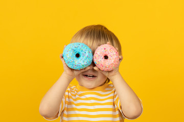 Wall Mural - Happy child holding glazed donut