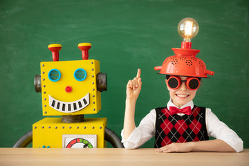 Canvas Print - Happy child with toy robot in school