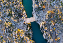 Concrete Slab Serving As A Bridge Spanning Rocky Banks Of Cijevna (Cem) River Near Podgorica And Tuzi In Montenegro At The Narrowest Part Of The Ravine. Straight Down Aerial Shot Of A Rocky Terrain.