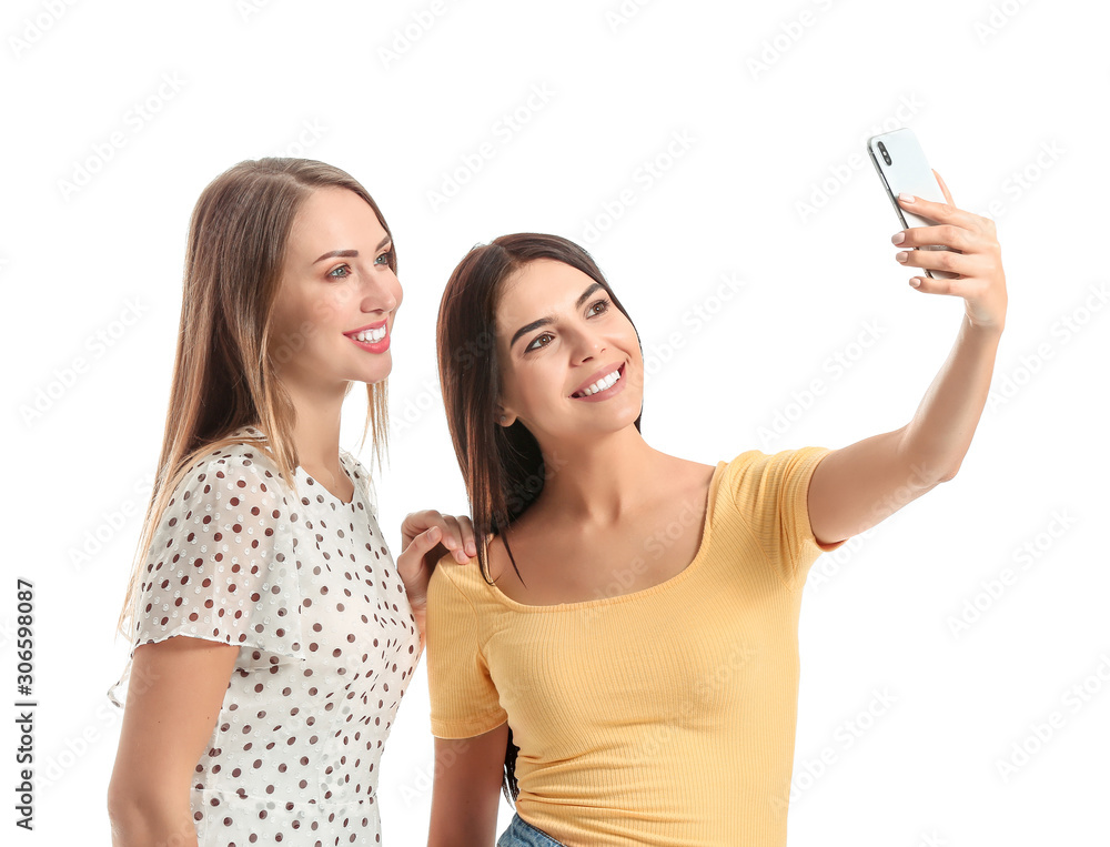 Happy women taking selfie on white background