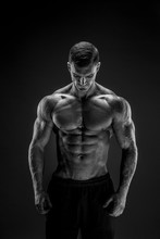 Very Brawny Guy Bodybuilder Posing. Beautiful Sporty Guy Male Power. Fitness Muscled Man In Studio. Dark Background.