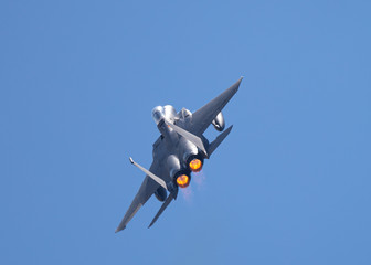 F-15 Eagle in a very close rear view, with afterburners on, in beautiful light 