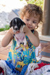 © Ilton Rogerio - Beautiful child playing with puppy
