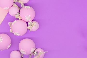 Flat lay, Christmas spheres, pink, white and purple background, Xmas and New Year holiday