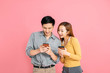 © Tom Wang - Cheerful young couple watching the smart phone