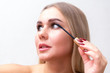 © Евгения Медведева - eyelashes make-up girl, young beautiful blonde paints eyelashes, applies mascara at home in the morning.