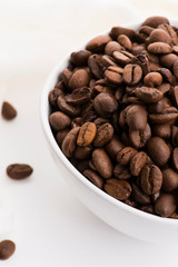 Bowl of caffee beans on a white background