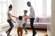 © fizkes - Happy african American family with kids dance together at home
