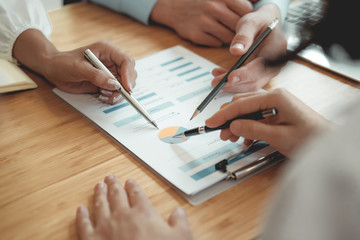 Wall Mural - business people discussing on performance revenue in meeting. businessman working with businesswoman.