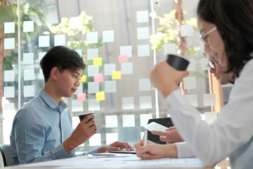 Wall Mural - business people discussing on performance revenue in meeting. businessman working with businesswoman.