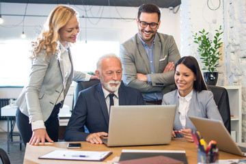 Group of business people having meeting with their senior boss in modern office